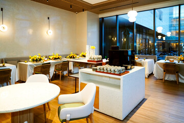 A buffet restaurant with yellow flowers on the tables