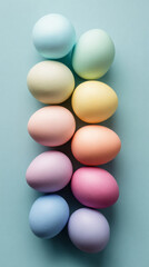 Brightly colored eggs in pastel shades are placed in a straight line on a soft surface. These eggs are commonly used during Easter for decoration and festivities
