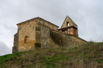 Stone exterior of San Miguel Church in Villavega de Ojeda with bell gable