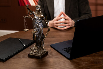 Law firm office featuring a statue of Themis with legal books and scales of justice, symbolizing fairness, law, and legal principles. Concept law, justice, legal tradition, professionalism. © Лиза Птицына