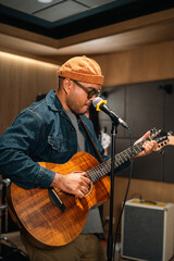 Obraz premium Young asian music group Band members rehearse with instruments guitar bass drum. Teamwork music band practice in studio prepire perform. Vocalist and band