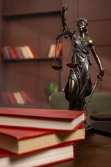 Bronze Lady Justice holding scales, symbol of legal authority and fairness. Law and business concept.