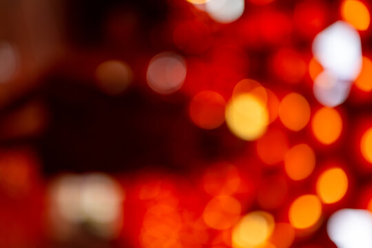 A warm and abstract red Chinese New Year lantern bokeh background"Abstract blurred background of vibrant red and golden orange bokeh lights. Perfect for festive celebrations, Christmas themes, luxury.
