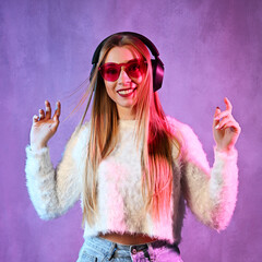 Portrait of dancing young woman with headphones