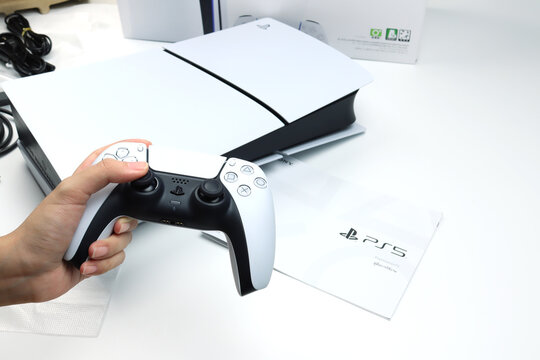unboxing moment of SONY PlayStation 5 Slim game console in original retail packaging on white background modern gaming technology concept, product reveal and packaging detail for Play Station console
