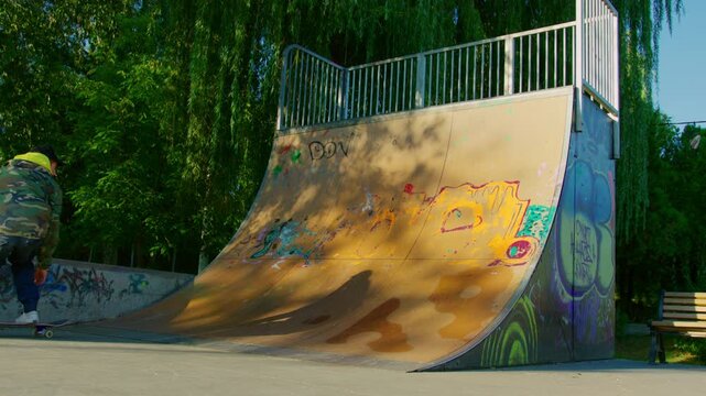 Skateboarder executing tricks on a ramp in a park