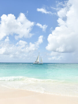 A Sail Boat in the Caribbean Sea as Seen from a Beach in Aruba