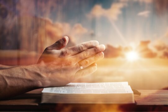 Man hands praying on the bible. Concept religion