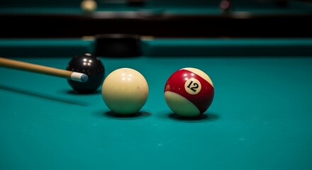 Pool cue striking a white ball on a green felt table with other balls nearby.