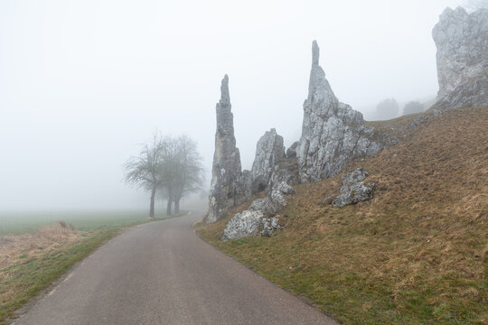 Spring, Mystic morning fog surrounding the Stone Virgins (Steinerne Jungfrauen) rock formation. Herbrechtingen, Baden-Wuerttemberg, Germany.