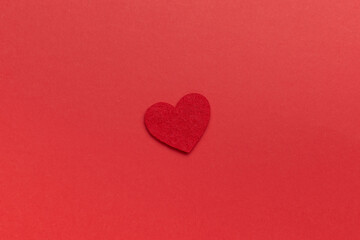 Minimalist Red Heart on Textured Red Background: Symbol of Love and Romance for Modern Design