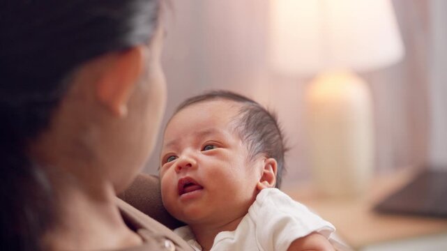Newborn baby finds comfort and safety in mother s arms. A tender moment of maternal care and trust.