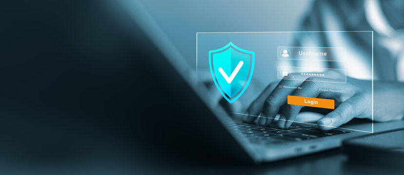 Close up of hands typing on laptop for secure login with shield icon and user authentication interface, cybersecurity and data privacy protection concept for business.