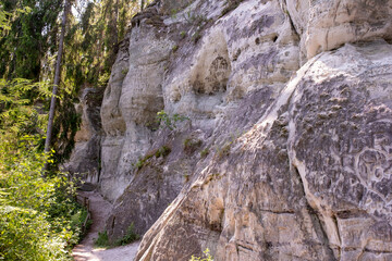 Hiking path along ancient sandstone cliff wall