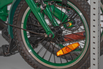 A folding bike lies on a shelf in close-up