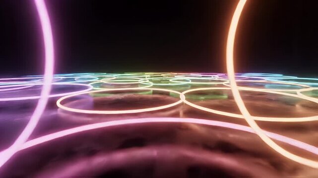 Abstract Neon Rings on Reflective Surface - Abstract glowing neon rings in pink, yellow, and blue colors hover over a reflective surface.