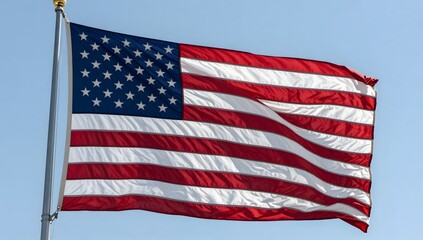 American flag waving gently in the breeze against a clear blue sky