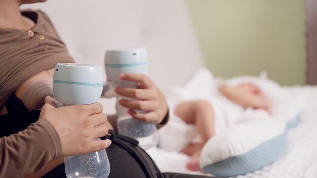 Mother pumping breast milk with electric pump while newborn sleeps. Concept of modern motherhood, breastfeeding, and baby care.