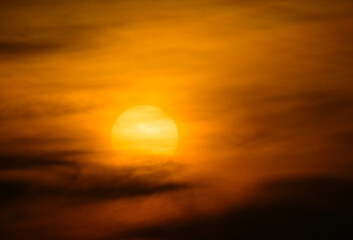 Obraz premium Sunrise over a misty cityscape from Dadao Mountain, Taiwan. The sun emerges from behind clouds, creating a dreamlike scene with layers of mountains and a vibrant orange sky.