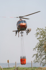Firefighting Helicopter in Action Collecting Water