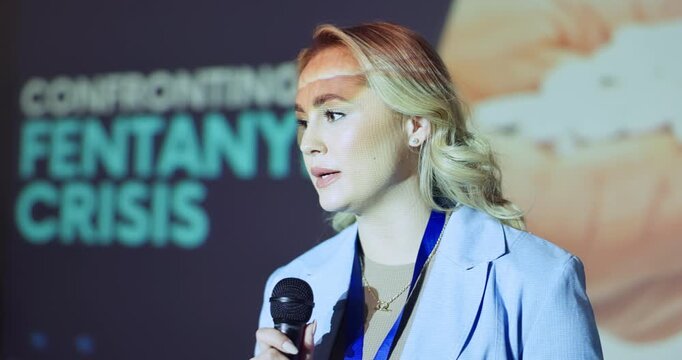 Seminar, woman and talking in speech with information, drug crisis awareness and fentanyl epidemic. Speaker, mic and public speaking in presentation for research findings, workshop or risk management