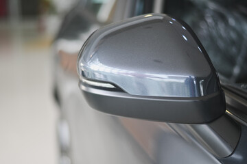 Modern grey side-view mirror of a car.