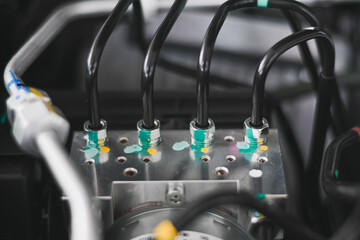 Mechanical pipes connected to a silver block in a car.