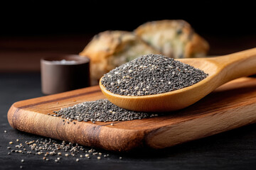 Poppy seed wooden spoon cutting board black background closeup healthy ingredient food kitchen natural