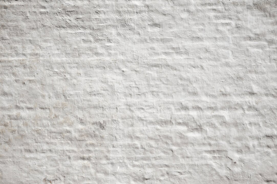 Wei&szlig; get&uuml;nchte Backsteinwand als Hintergrund