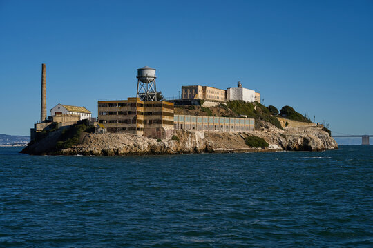 San Francisco, USA - October 27, 2025 - Alcatraz Island prison complex with water tower and smokestack on a clear day