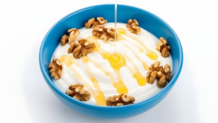 Indulge in creamy Greek yogurt topped with fresh walnuts and golden honey, elegantly drizzled in a vibrant blue bowl on a clean white background. Perfect healthy breakfast or snack.
