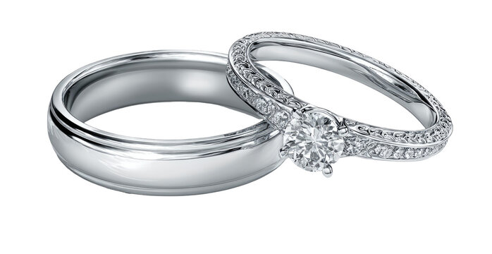 Two elegant, overlapping wedding bands, one with a center diamond and pave setting