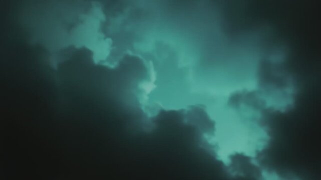 Teal sky with layered clouds of differing brightness creating a serene natural background, representing themes of weather, environment, and open space