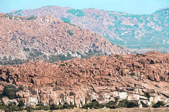 Scenic pilgrimage path on Anjanadri Hill featuring 575 steps surrounded by granite boulders near Hampi, India.