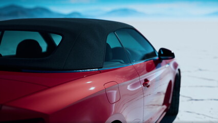Naklejka premium A striking red convertible stands by itself on an expansive cracked ground, surrounded by distant mountains and a bright blue sky.