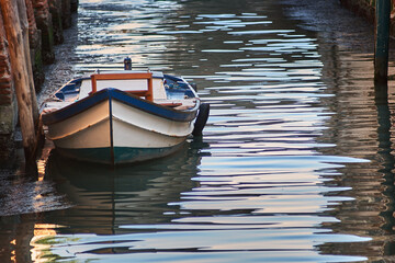 Traditional boat floating peacefully on water channel