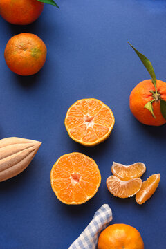 Fresh mandarins arranged on a vibrant blue background