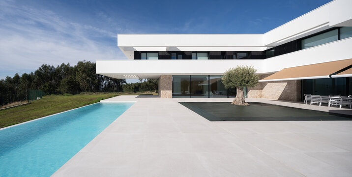 Modern luxury home exterior with pool and terrace