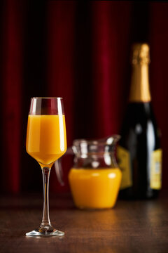 Mimosa cocktail with orange juice in elegant glass