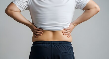 A woman pinches excess skin on her lower back, highlighting a common area of body awareness. This image relates to health, wellness, and self-acceptance journeys