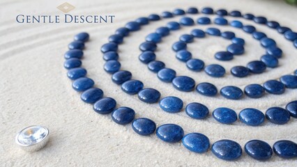 Natural Blue Stones Arranged in Spiral Pattern on Soft Sand Surface