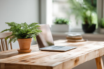 Naklejka premium A minimalist home office that combines technology and nature with a desk, laptop, and a pot of ferns.