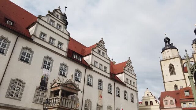 Historic market square of Wittenberg in Germany with town hall, church and Martin Luther statue