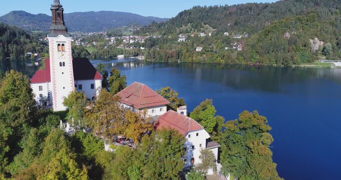 Aerial view of lakeside village and island in clear blue alpine lake