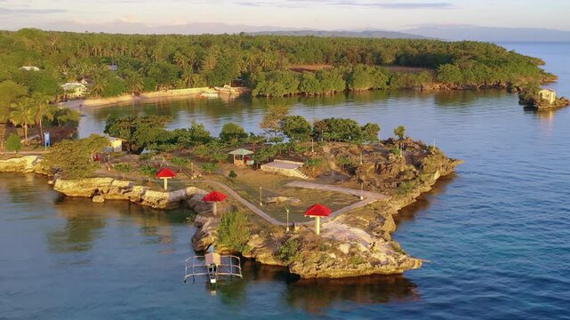 Aerial view of small tropical island resort surrounded by blue sea