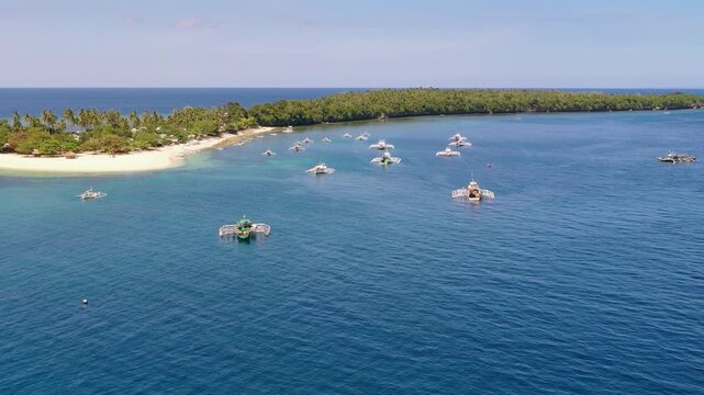Aerial view of tropical bay with boats on calm blue sea