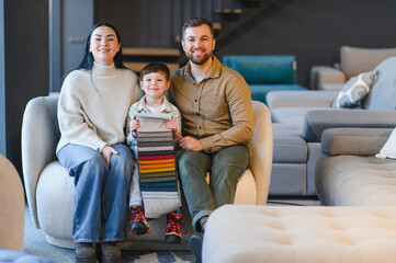 Naklejka premium Family choosing new furniture fabric samples in store