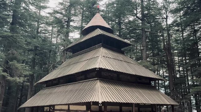 Ancient Hidimba Devi Temple in Manali featuring traditional wooden pagoda-style architecture surrounded by dense cedar forest in the Himalayan region of Himachal Pradesh, India.