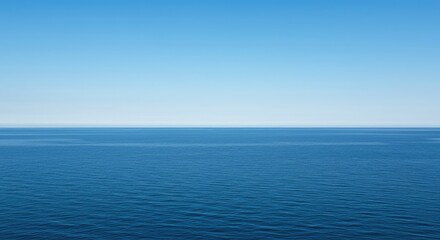 Obraz premium A vast expanse of deep blue water stretches toward the distant horizon under a bright summer sky, blending the scale of the sea with inland calm ,liquid ,blue ,travel