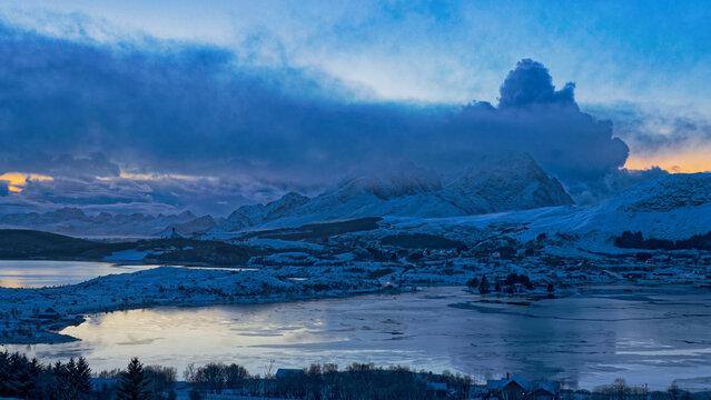 Panoramic view from the Borg area and frozen lakes on a cold hazy winter afternoon. Lofoten Islands, Northern Norway